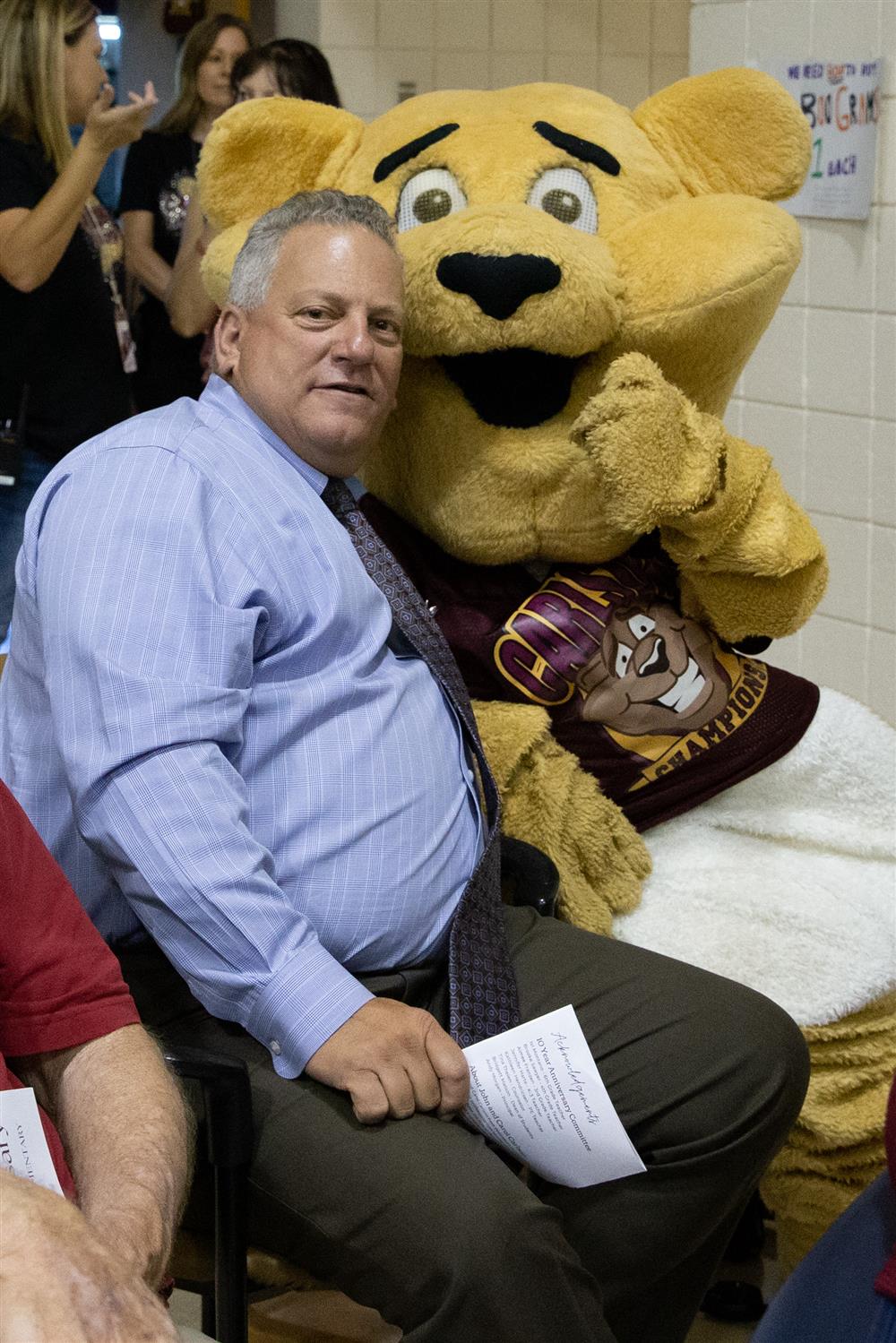 CUSD Superintendent Frank Narducci sits with Carlson Elementary's mascot named Champ.